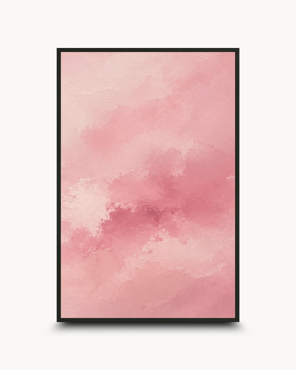 A framed abstract art print featuring a soft watercolor-like pink and peach cloud pattern, presented in a black frame against a clean white background.