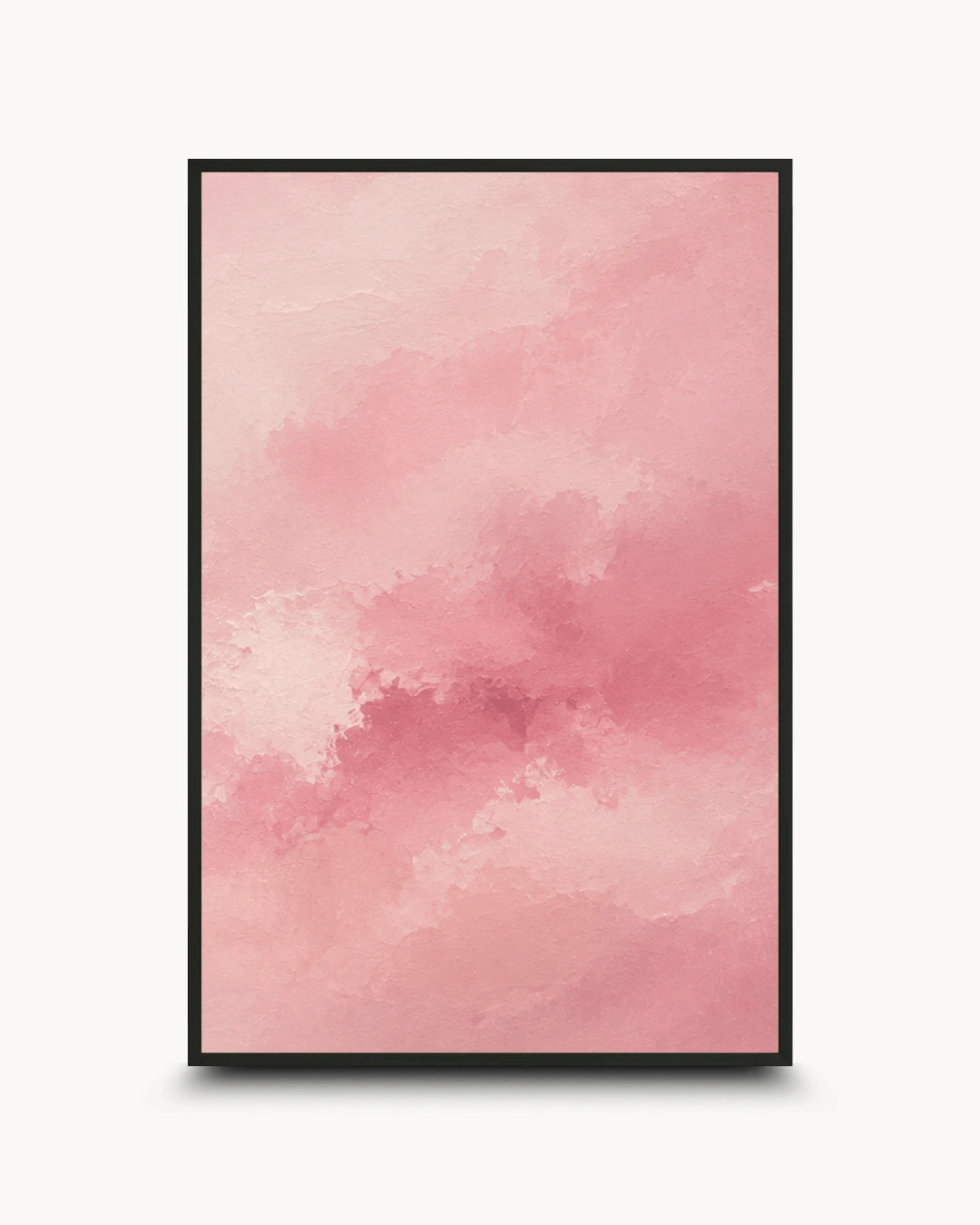 A framed abstract art print featuring a soft watercolor-like pink and peach cloud pattern, presented in a black frame against a clean white background.
