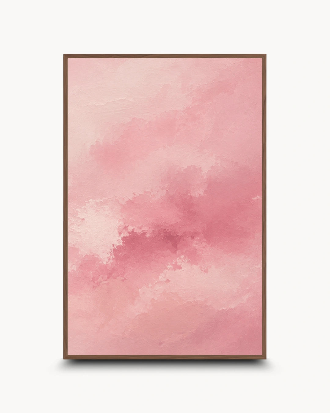 A framed abstract art print featuring a soft pink watercolor texture with a thin brown frame, displayed against a clean white background.