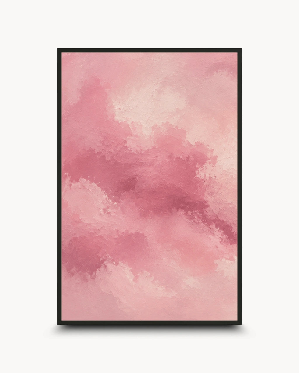 A framed abstract art print featuring a watercolor-style pink cloud pattern, presented in a black frame against a clean white background.