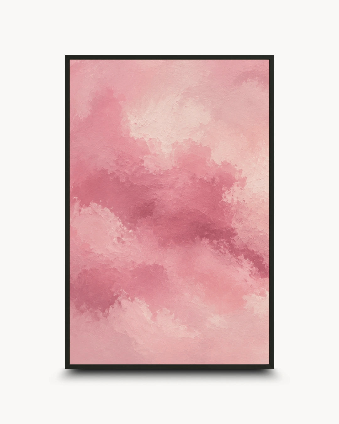 A framed abstract art print featuring a watercolor-style pink cloud pattern, presented in a black frame against a clean white background.