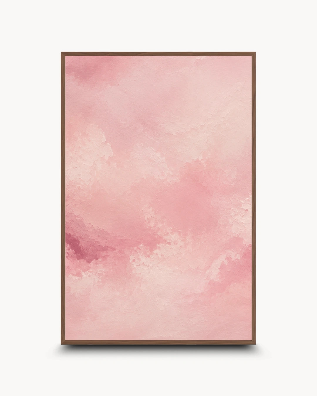 A framed abstract art print featuring a soft pink watercolor texture with a thin brown frame, displayed against a clean white background.
