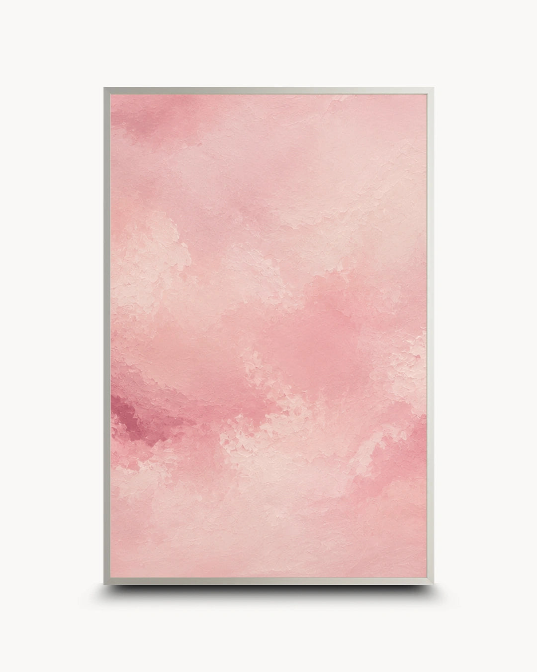 A vertical framed art print featuring a soft pink watercolor texture with a thin gold frame, shown against a clean white background with a subtle drop shadow.