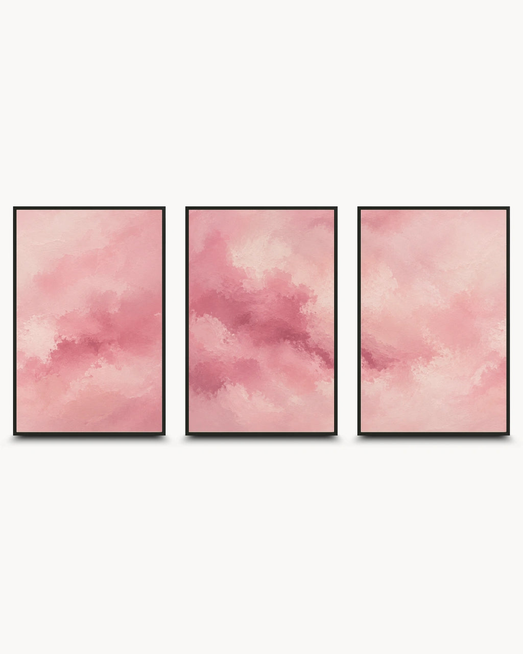 Three vertical framed wall art prints with soft pink watercolor-like abstract clouds, arranged side by side on a light gray background.