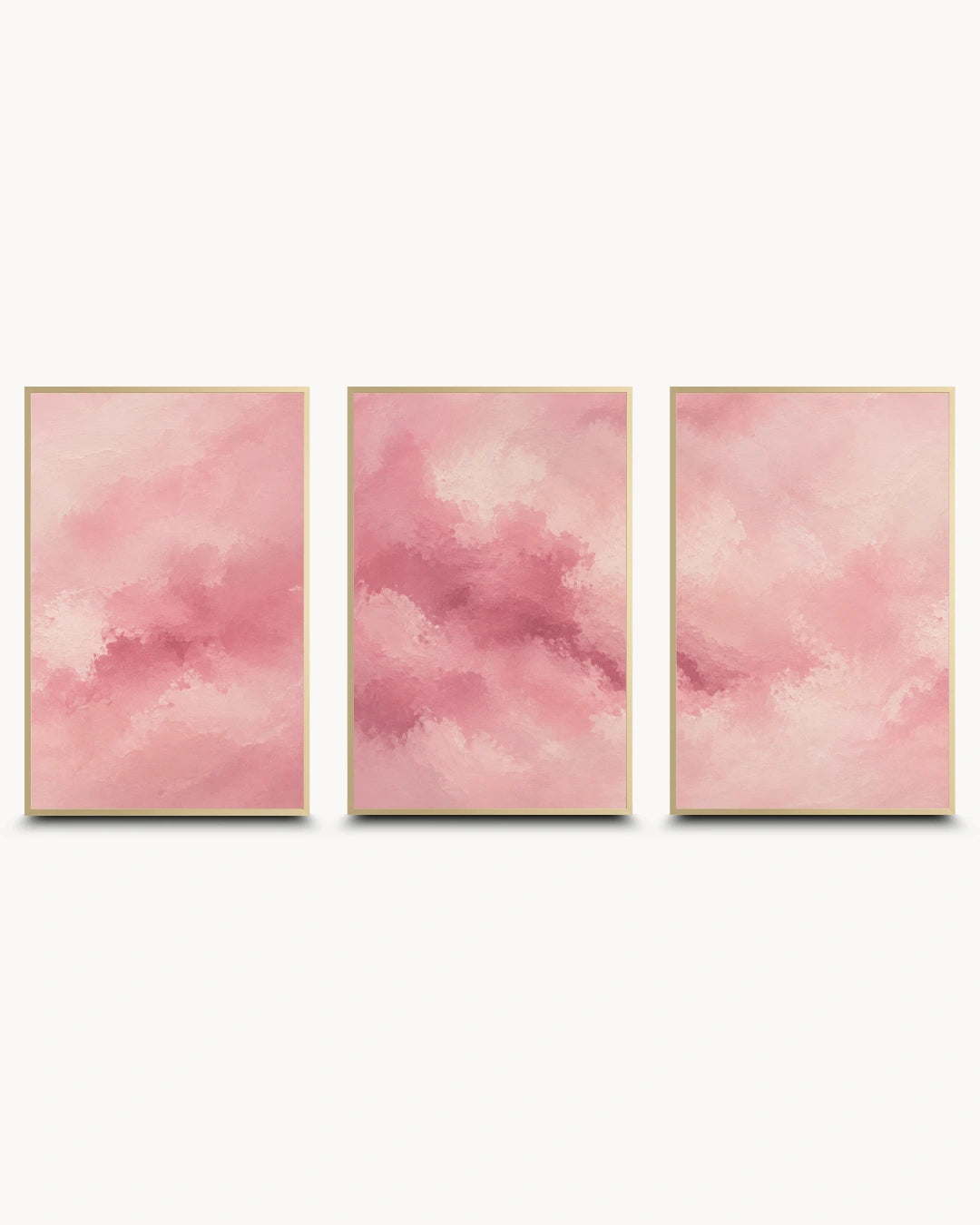 Three vertical framed wall art panels with soft pink watercolor-like abstract clouds, arranged side by side on a light gray background.