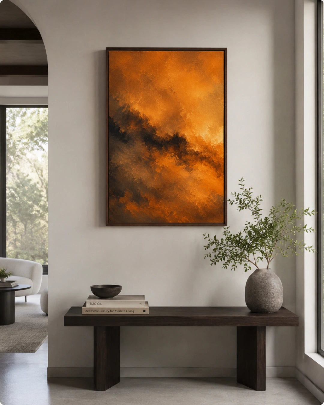A framed abstract painting with vibrant orange and dark brown cloud-like textures hangs on a light gray wall above a dark wooden bench in a modern living room setting.