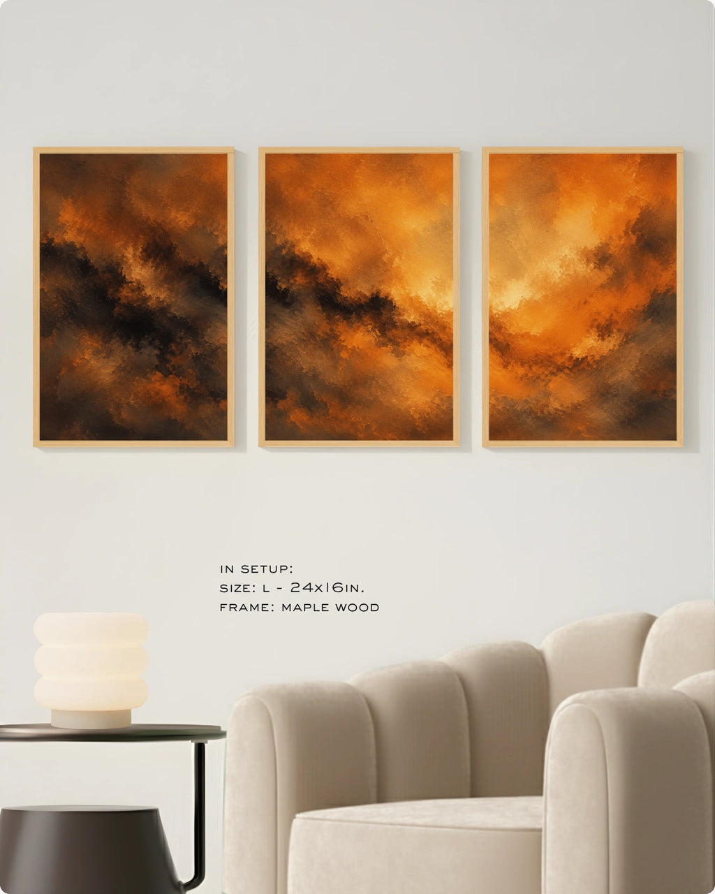Three framed abstract wall art prints with fiery orange, brown, and black brushstrokes displayed above a light beige armchair in a modern room setting. Small text below reads 'IN SETUP: SIZE: L-24x16in.