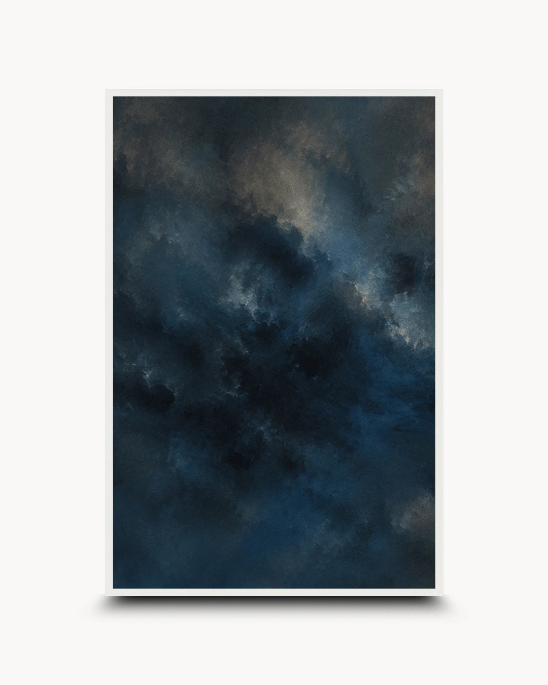 A vertical framed art print featuring a dark, moody abstract sky design in deep navy, blue, and gray tones with subtle light streaks, presented on a clean white background with a soft drop shadow.