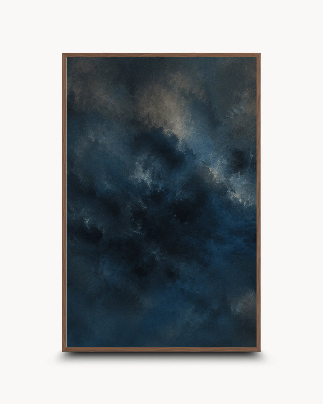A vertical framed art print featuring a dark, moody abstract sky design in deep navy, blue, and gray tones with subtle light streaks, presented on a clean white background with a soft drop shadow.