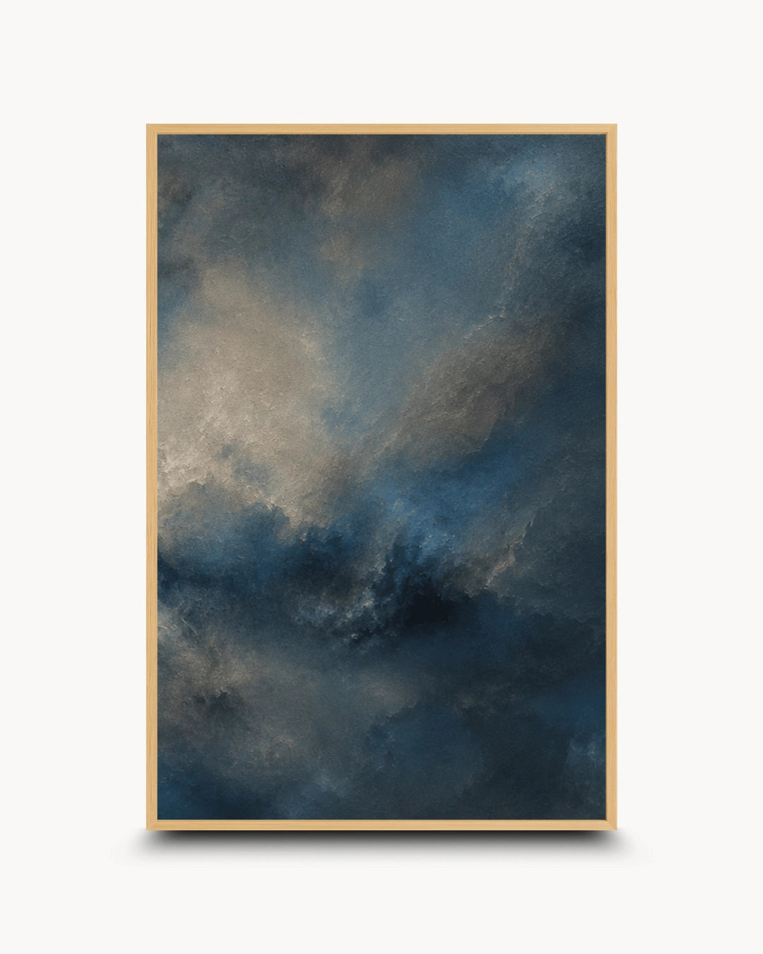 A framed abstract art print featuring a dramatic, textured sky-like composition in deep blue, charcoal gray, and muted beige tones, displayed against a clean white background.