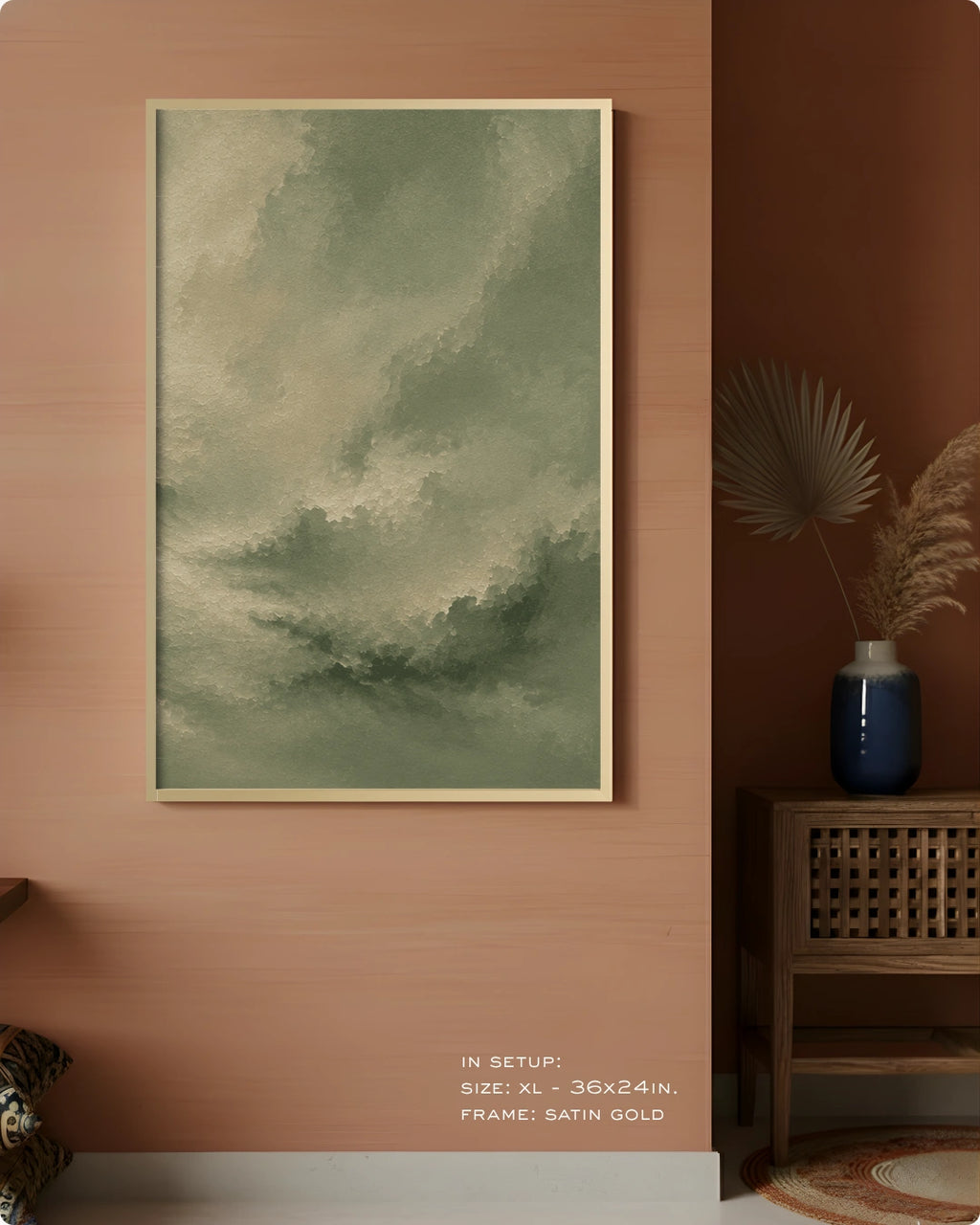 A framed wall art print featuring a muted green and gray cloudy sky, displayed in a vertical orientation on a terracotta-colored wall in a styled interior setting.