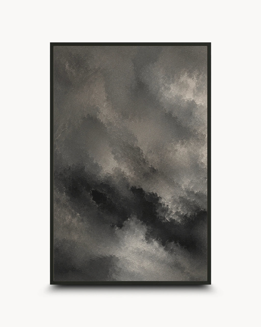 A framed abstract art print featuring a dramatic, textured cloud-like composition in shades of charcoal gray, black, and off-white, set against a clean white background.