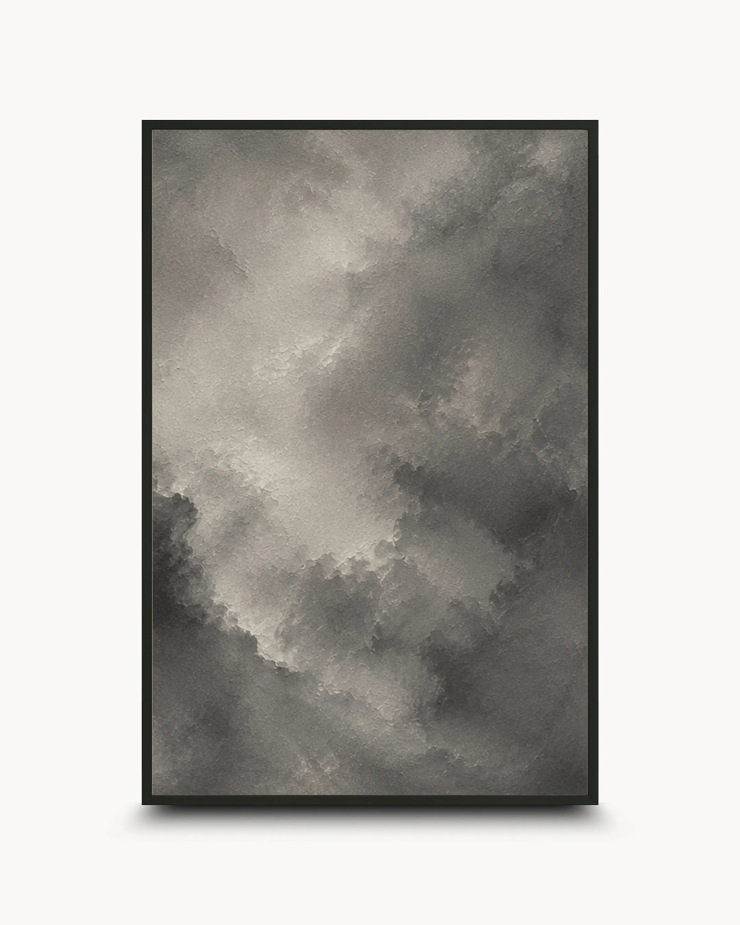 A framed abstract art print featuring a textured, painterly cloud-like composition in shades of gray, charcoal, and off-white, set against a clean white background.