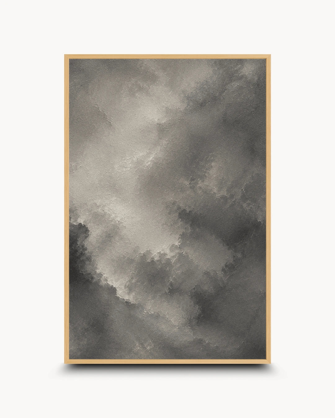 A framed abstract art print featuring a textured, painterly cloud-like composition in shades of gray, charcoal, and off-white, set against a clean white background.