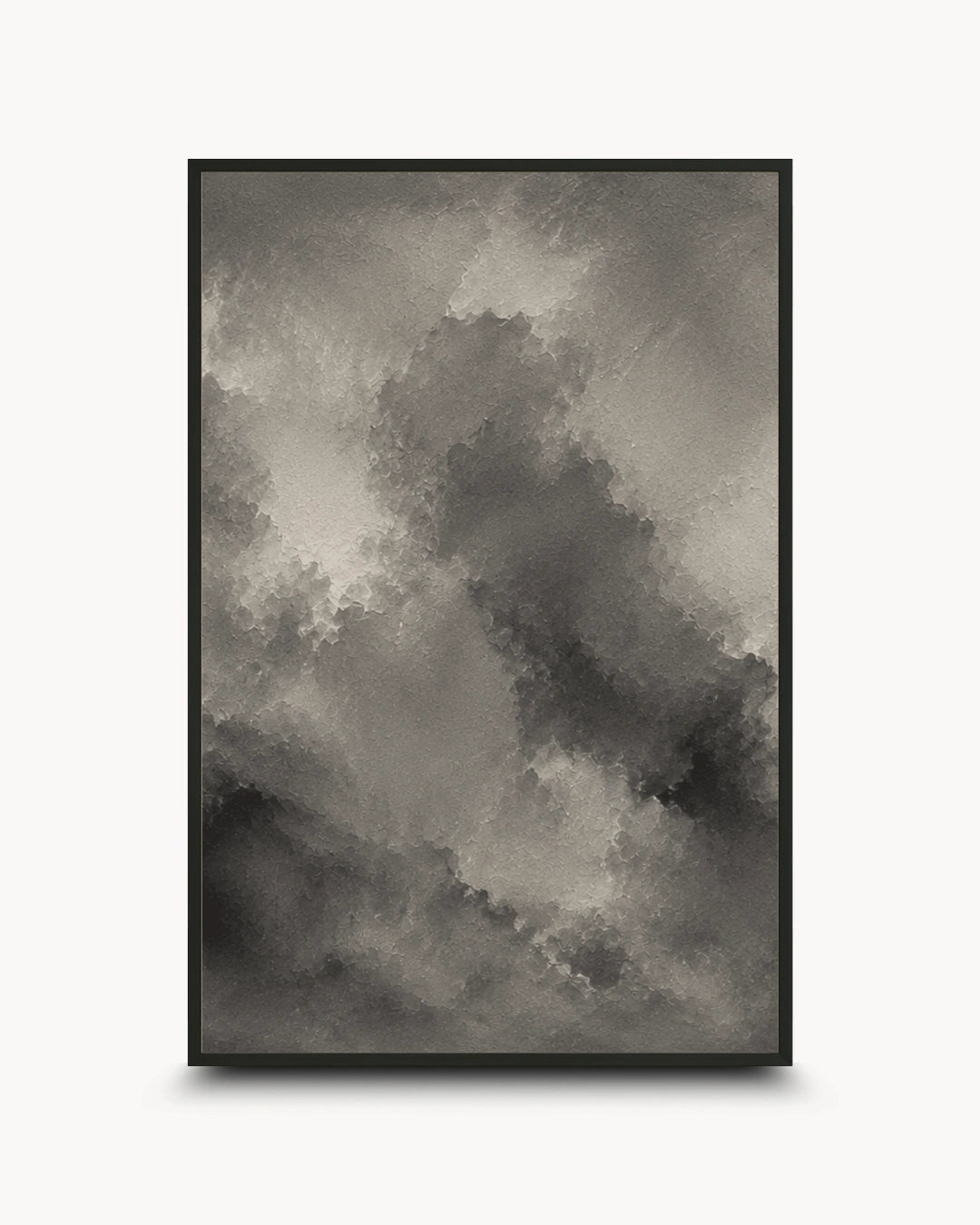 A framed abstract art print featuring a textured, painterly cloud-like composition in shades of gray, black, and white, set against a clean white background.