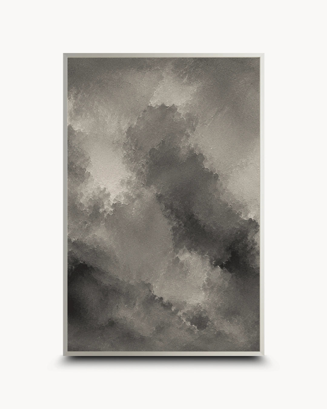 A framed abstract art print featuring a textured, painterly cloud-like composition in shades of gray, black, and white, displayed against a clean white background.