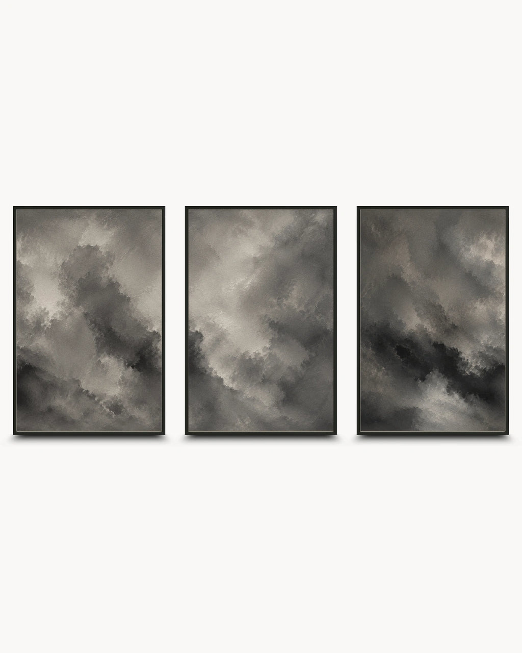 Three framed vertical wall art prints with dark gray and black cloudy abstract designs, arranged side by side on a light gray background.