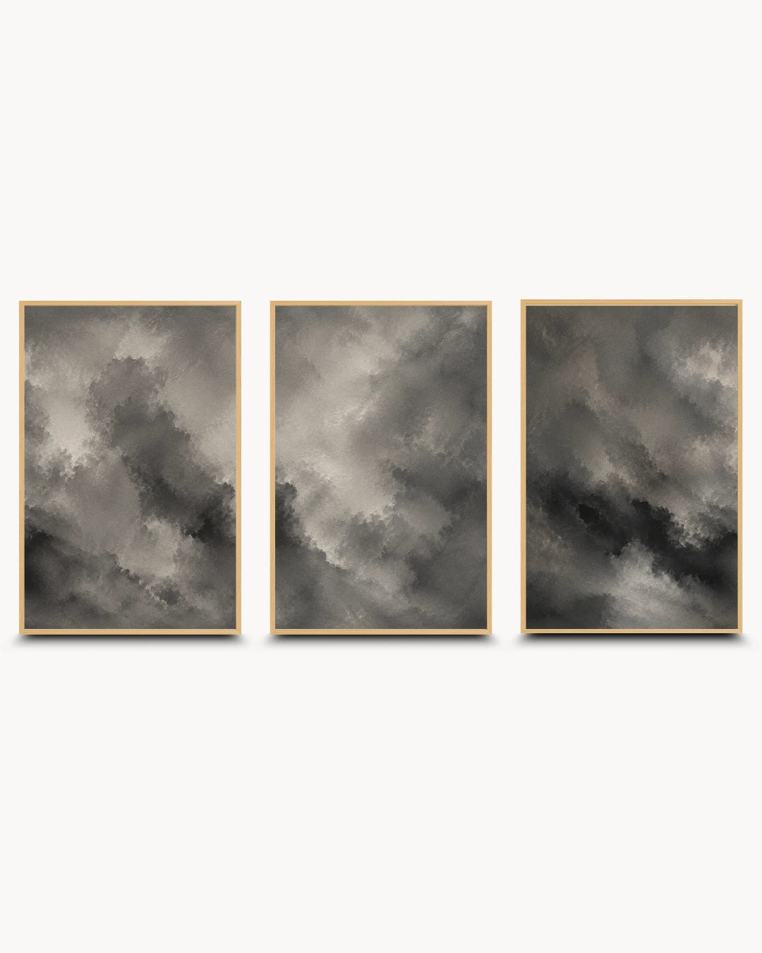 Three framed vertical wall art prints with abstract cloudy imagery in gray, black, and white tones, arranged side by side on a light gray background.