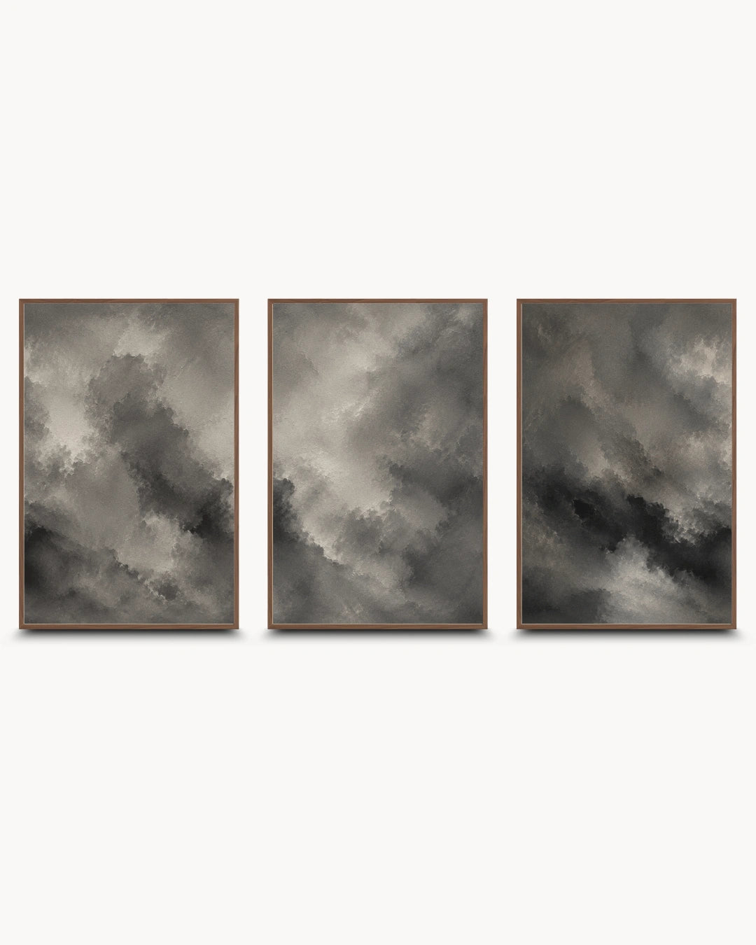 A three-piece framed wall art set featuring dramatic gray and black cloudy abstract prints with thin brown frames, displayed side-by-side on a light gray background.