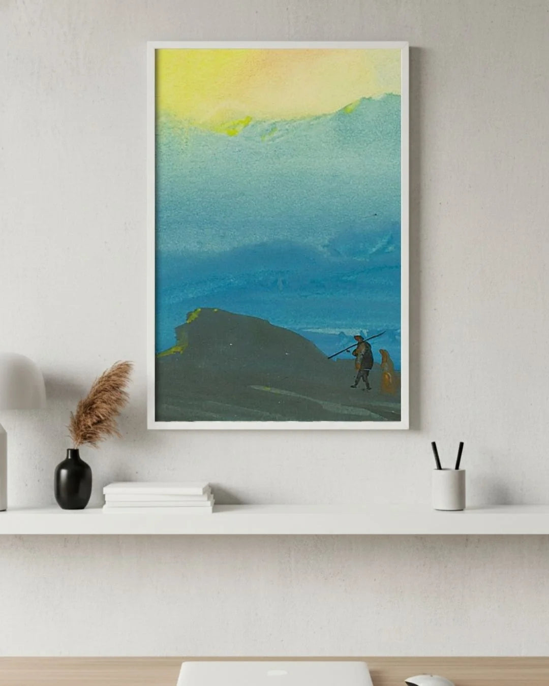 Bireswar Das "The Mountains of Gold" Himalayan landscape in a 0.5-inch Moon White frame, styled above a white minimalist desk with pampas grass.