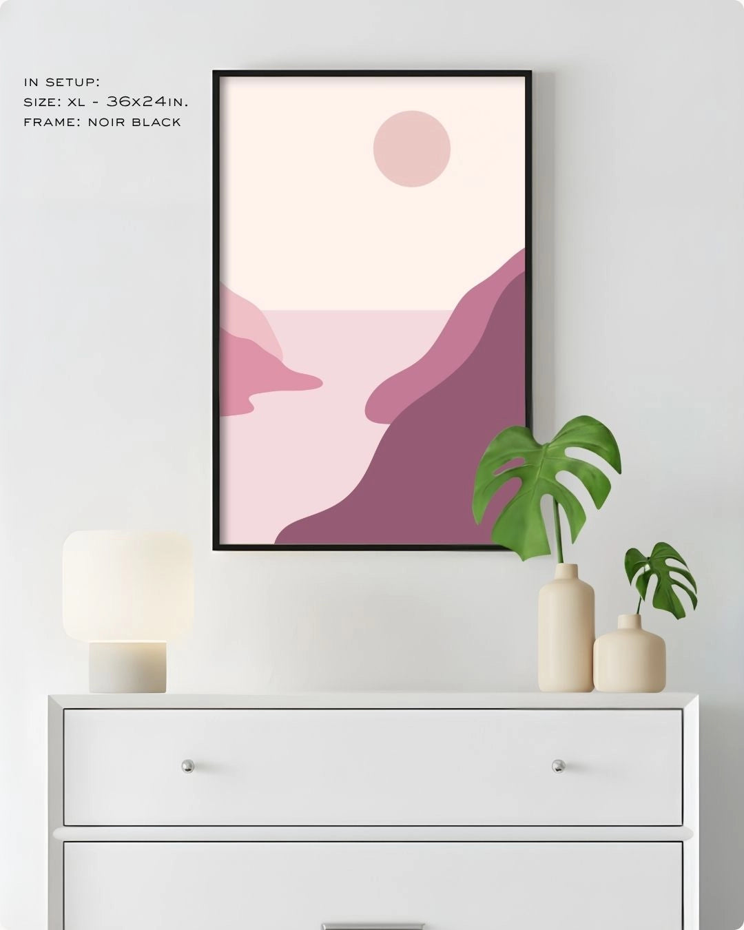 Extra Large (XL) Blush Valley landscape wall art by K2C Co. in a Noir Black frame, hanging above a white dresser in a clean bedroom mockup with a Monstera plant.