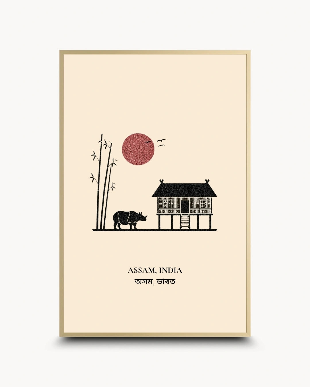 A framed art print featuring a minimalist illustration of Assam, India, with a stilt house, rhinoceros, bamboo, and a red sun on a cream background, enclosed in a thin gold frame.