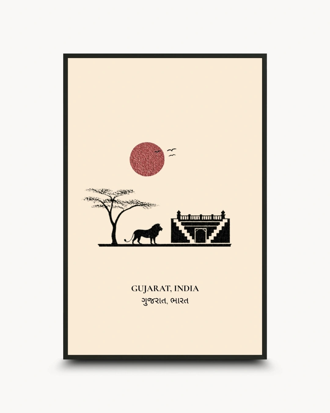 A framed travel art print of Gujarat, India, featuring a minimalist black and red design on a cream background with a silhouette of a lion, tree, and temple, shown in a black frame against a light gray background.