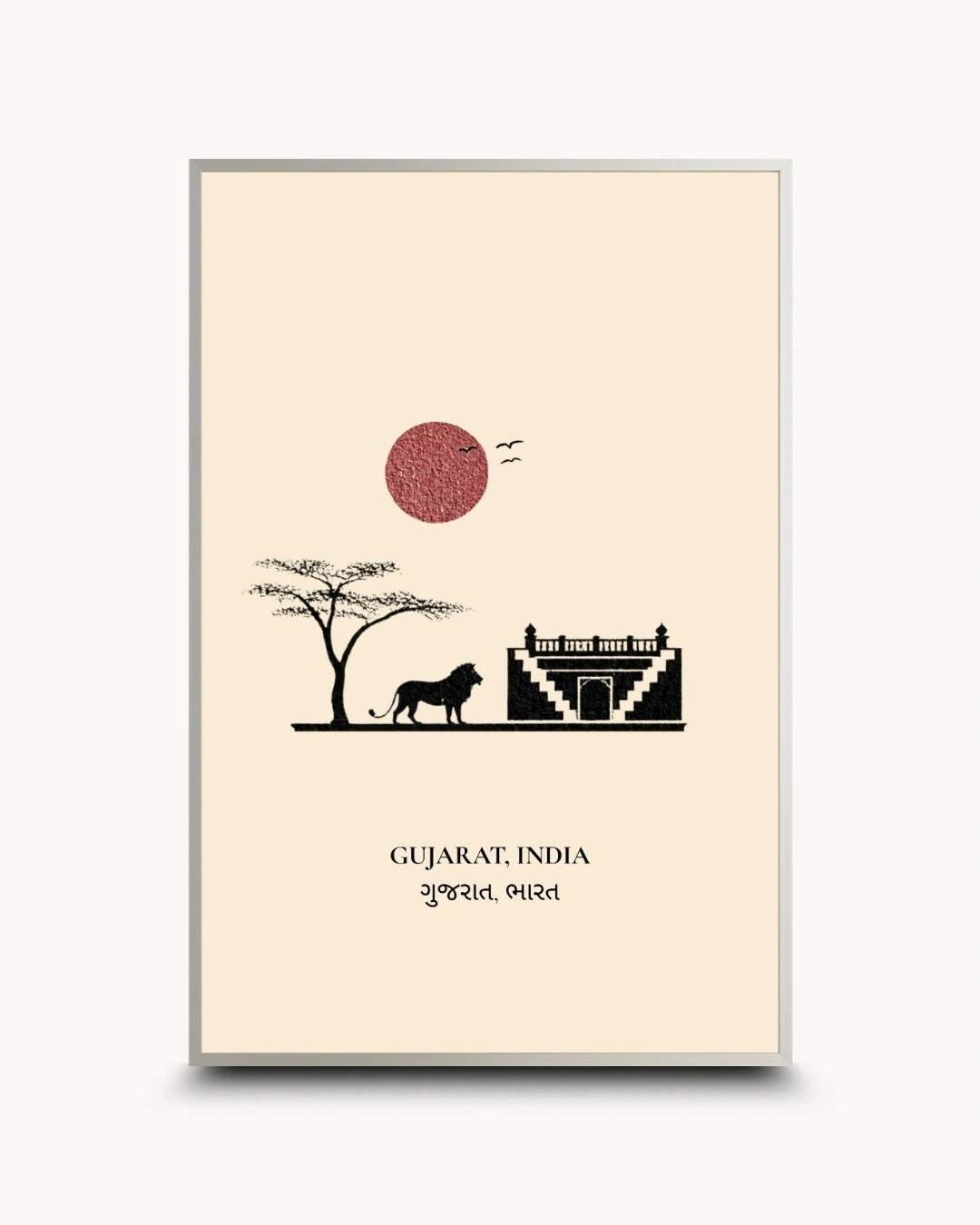 A framed art print featuring a minimalist illustration of Gujarat, India, with a black silhouette of a lion and tree, a red textured sun, and a white architectural structure on a cream background, enclosed in a thin gold frame.