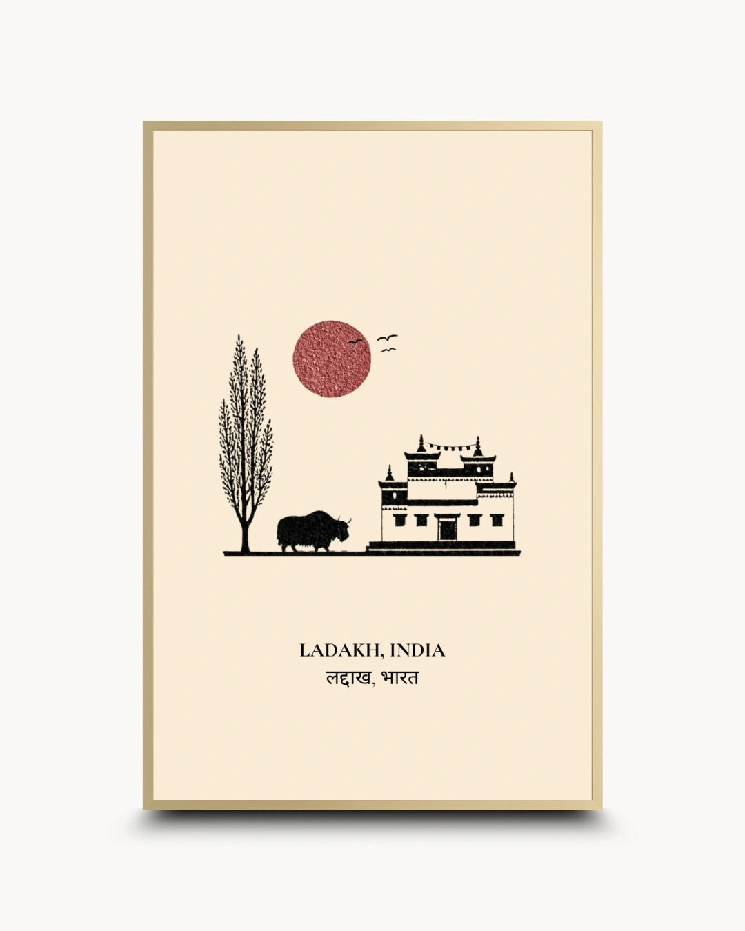 A framed travel art print of Ladakh, India, featuring a minimalist black line drawing of a building, a tree, a buffalo, and birds against a warm cream background with a textured red sun. The text 'LADAKH, INDIA' and 'लद्दख, भारत' are printed at the bottom.