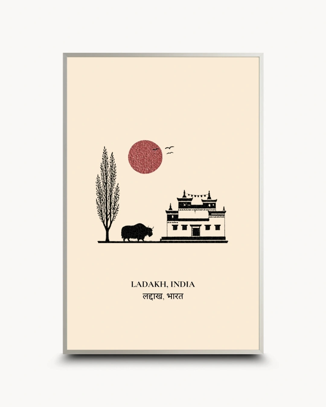 A minimalist travel poster of Ladakh, India, featuring a black line art illustration of a snow-capped mountain palace, a tree, a bison, and a red sun on a cream background, shown with a thin silver frame.