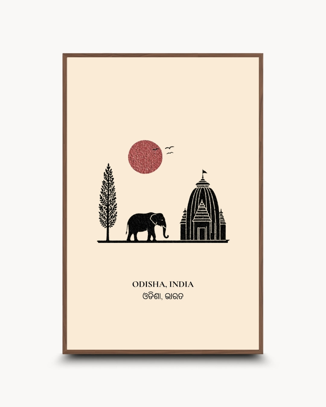 A minimalist framed art print featuring a black silhouette of an elephant, a tree, and a temple on a cream background, with a red sun and the text 'ODISHA, INDIA' at the bottom. The print is shown in a brown frame against a light gray background.