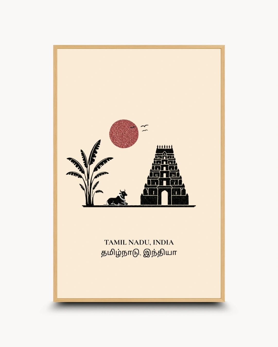 A framed minimalist art print of Tamil Nadu, India, featuring a black silhouette of a temple, palm tree, and cow under a red sun on a cream background, enclosed in a light wood frame.