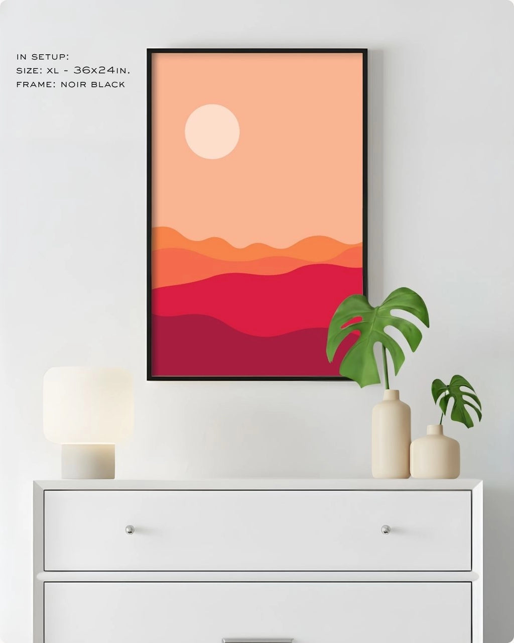 Extra Large (XL) Desert Dusk landscape wall art by K2C Co. in a Noir Black frame, hanging above a white dresser in a clean bedroom mockup with a Monstera plant.