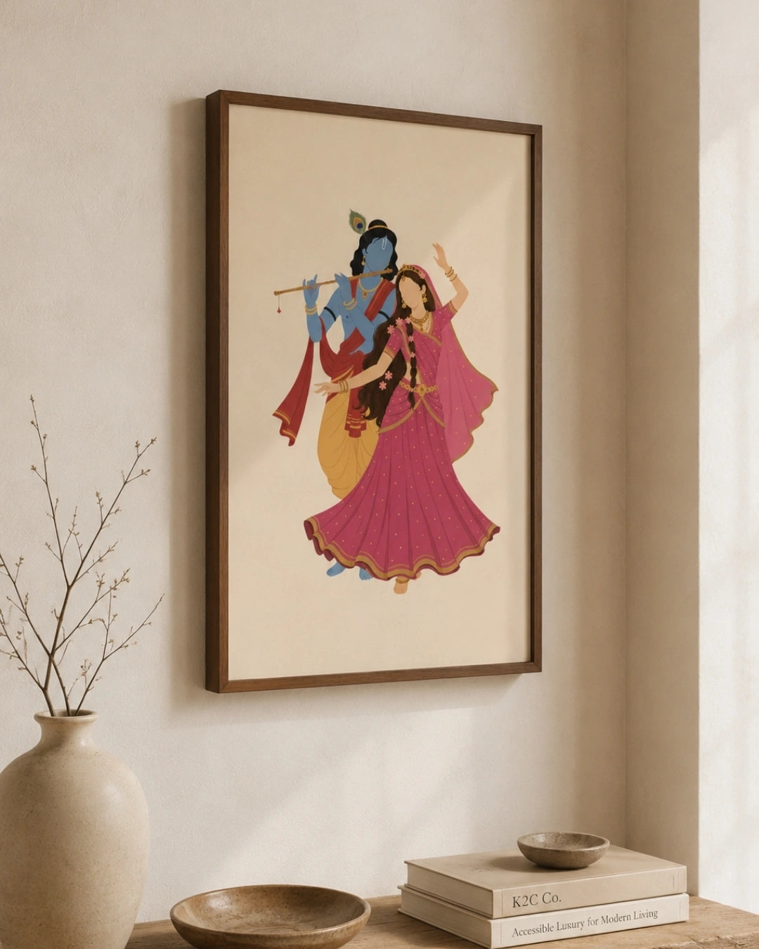 Lifestyle interior mockup of the Hindu divine couple Radha and Krishna wall art with a walnut wood frame, paired with wabi-sabi elements like dry botanical branches and ceramic vases.