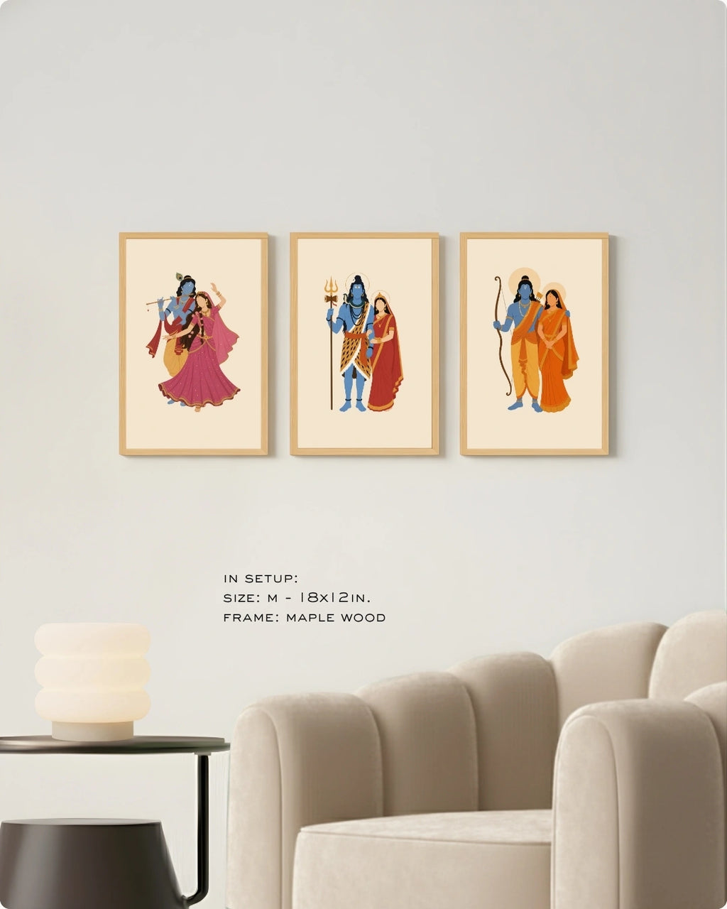 Visual size guide mockup for the Hindu divine couples wall art set of 3 in Medium size with maple wood frames, shown scaled perfectly next to a contemporary beige armchair.