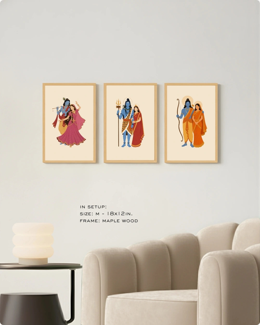 Visual size guide mockup for the Hindu divine couples wall art set of 3 in Medium size with maple wood frames, shown scaled perfectly next to a contemporary beige armchair.
