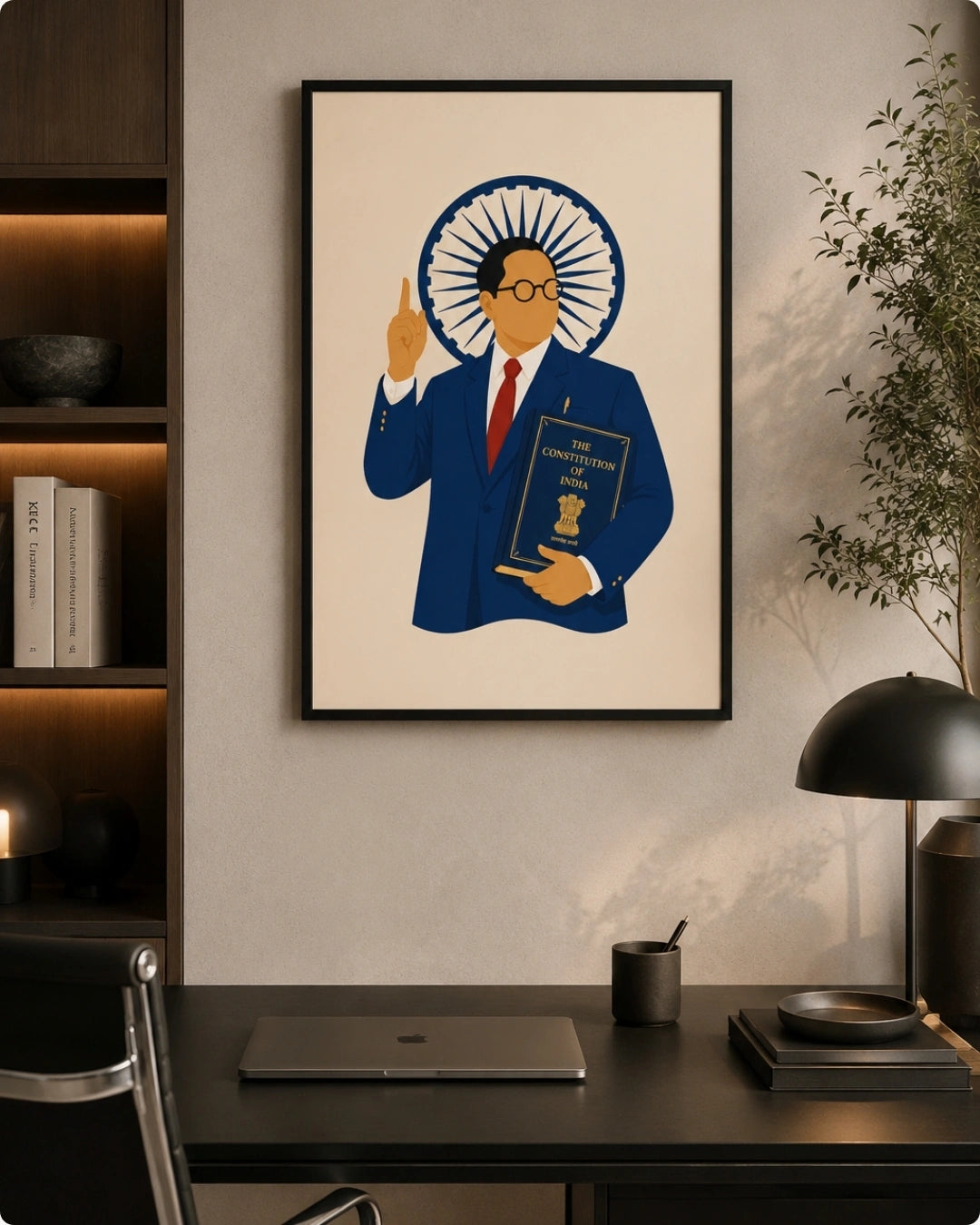 Lifestyle mockup of the Dr. B.R. Ambedkar wall art in a sleek black frame styled above a dark modern desk with a minimalist lamp and books.