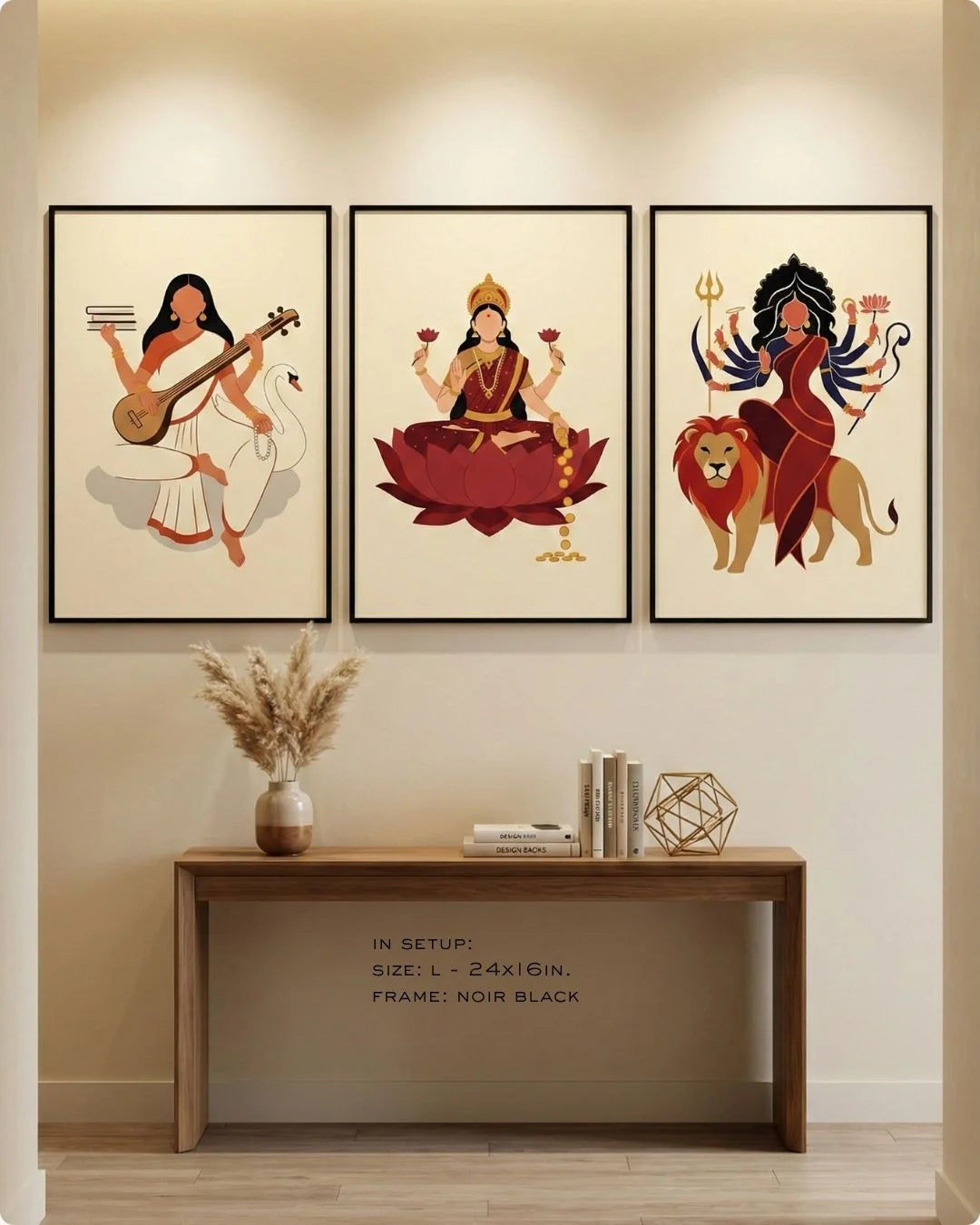 Curated spiritual triptych of Saraswati, Laxmi, and Durga in Maple Wood frames, styled above a light gray sofa in a modern living room.