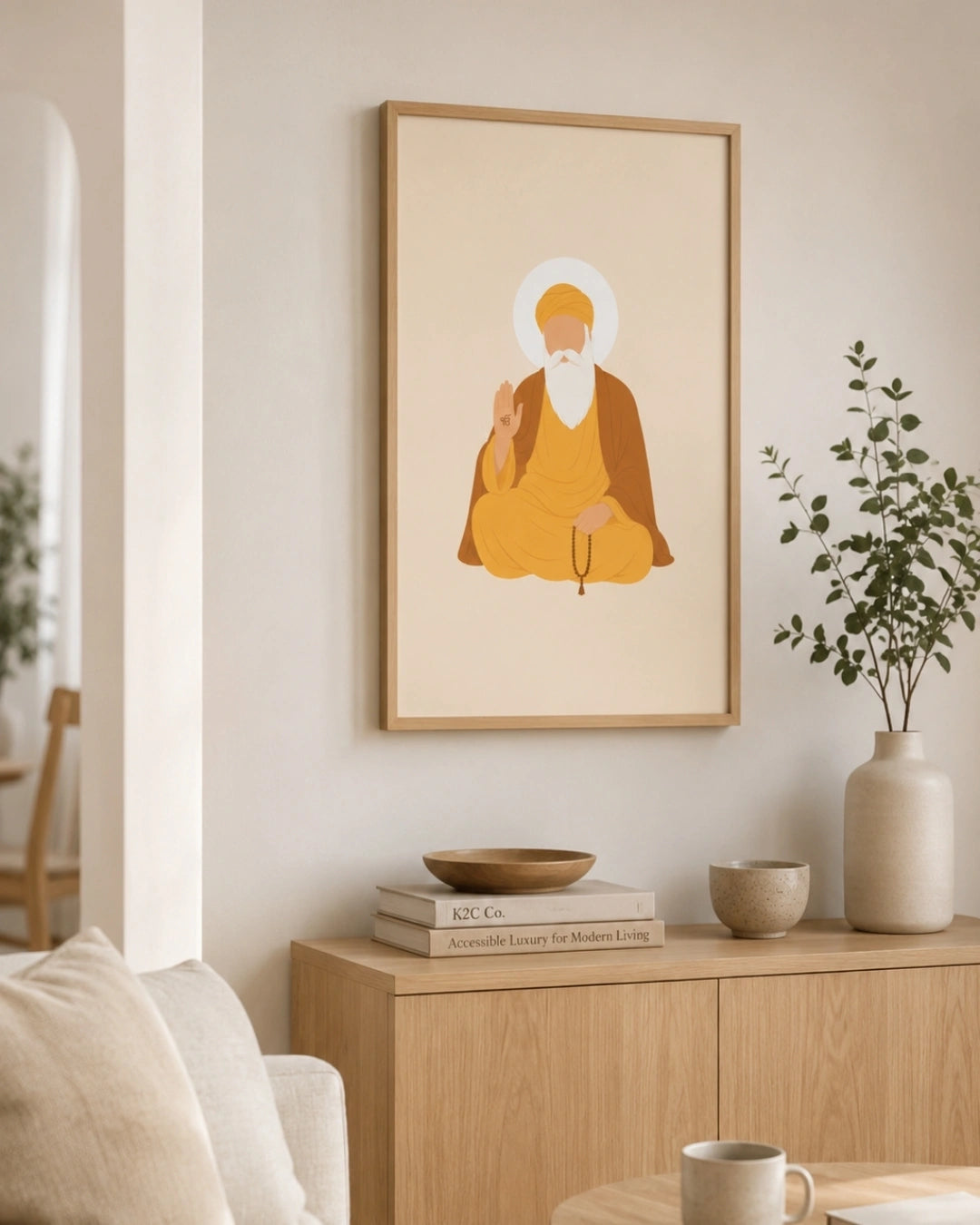Lifestyle mockup of the minimalist Sikh founder Guru Nanak Dev Ji wall art in a maple wood frame, styled above a light wooden cabinet in a bright Japandi living space.