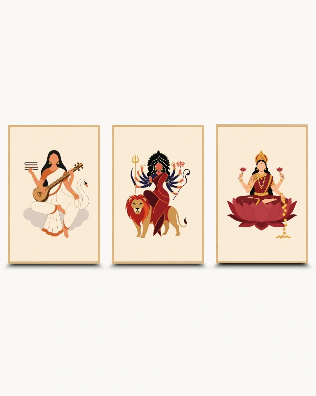 A set of three framed art prints featuring stylized illustrations of Hindu goddesses: Sarawati, Durga, and Lakshmi, shown against a light gray background.