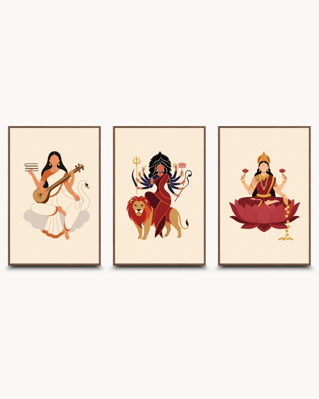 A set of three framed wall art prints featuring stylized illustrations of Hindu goddesses: Sarawati, Durga, and Lakshmi. The prints are arranged side by side against a light gray background.