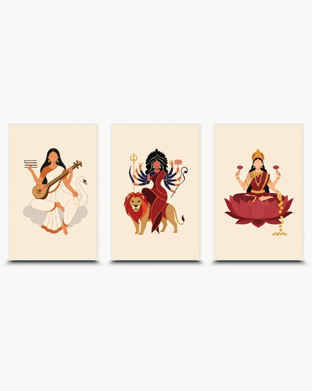 A set of three vertical art prints featuring stylized illustrations of Hindu goddesses: Saraswati playing a veena, Durga with a lion, and a seated Lakshmi on a lotus. The prints are arranged side by side on a light gray background.