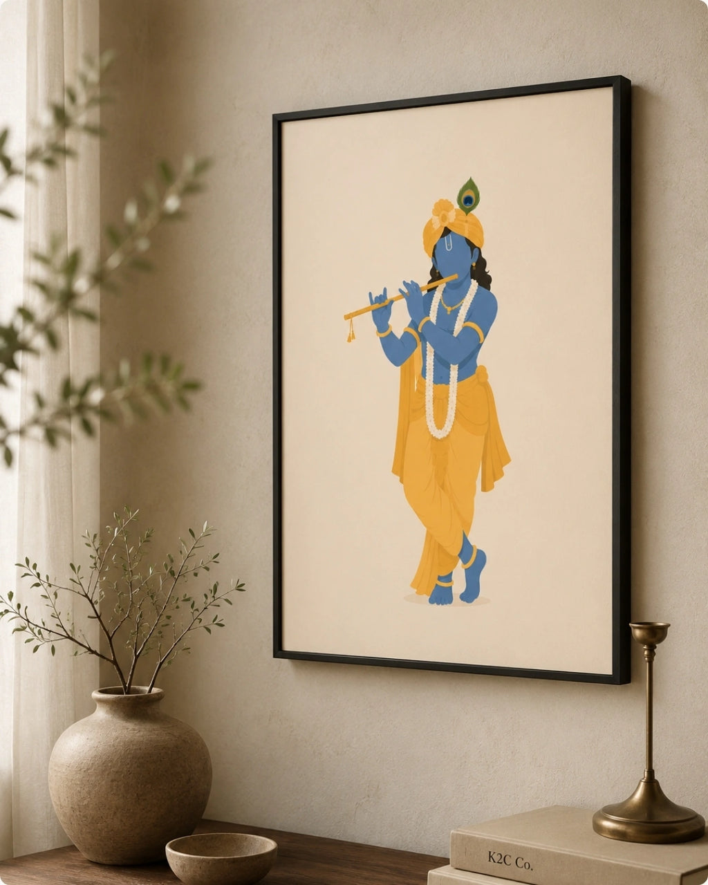A framed art print featuring a stylized illustration of the Hindu deity ISKCON Krishna in blue and yellow, hanging on a beige wall in a styled room setting with a vase, candle holder, and books.