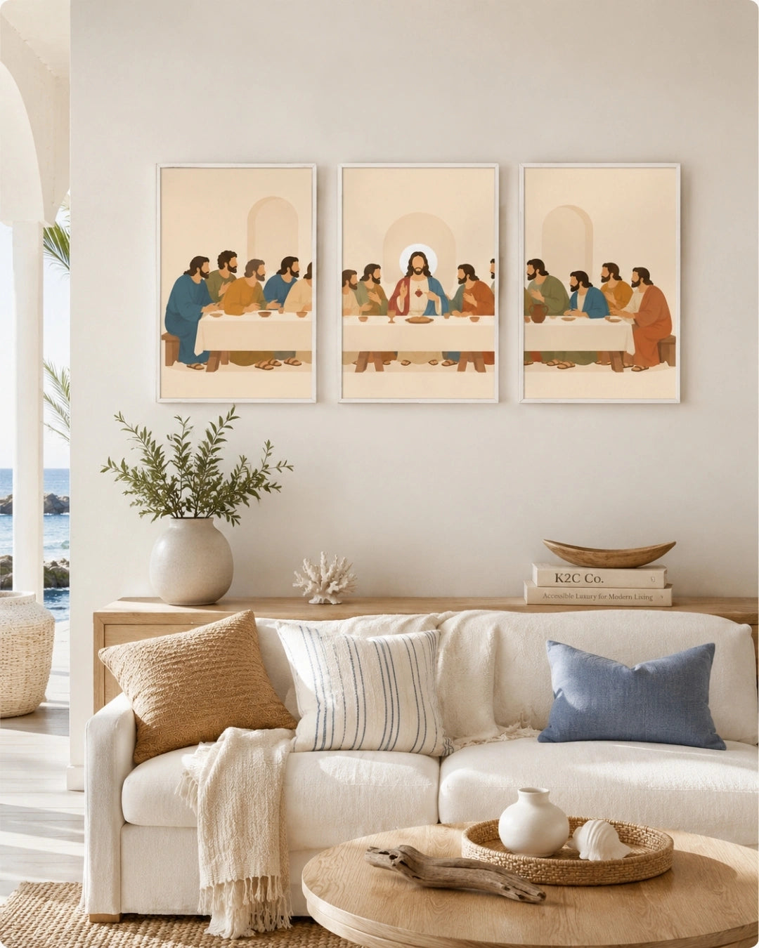 A three-panel framed wall art set depicting a stylized biblical scene with figures seated around a table, displayed above a white sofa in a bright, modern living room.