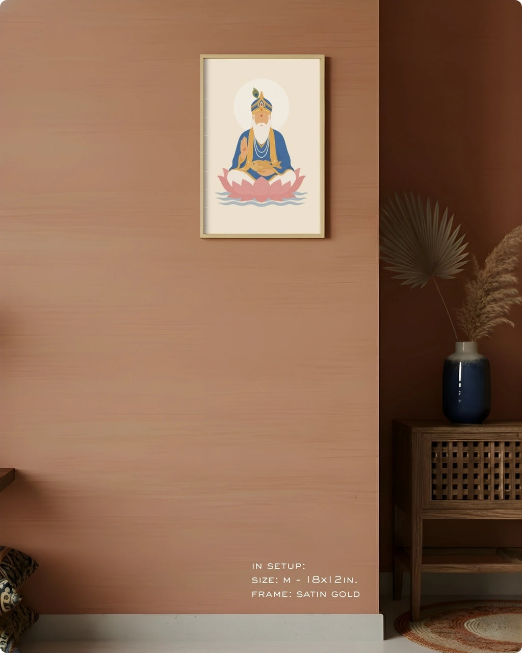 Visual size guide mockup for the Lord Jhulelal wall art in Medium size with a satin gold frame displayed against a warm terracotta accent wall.