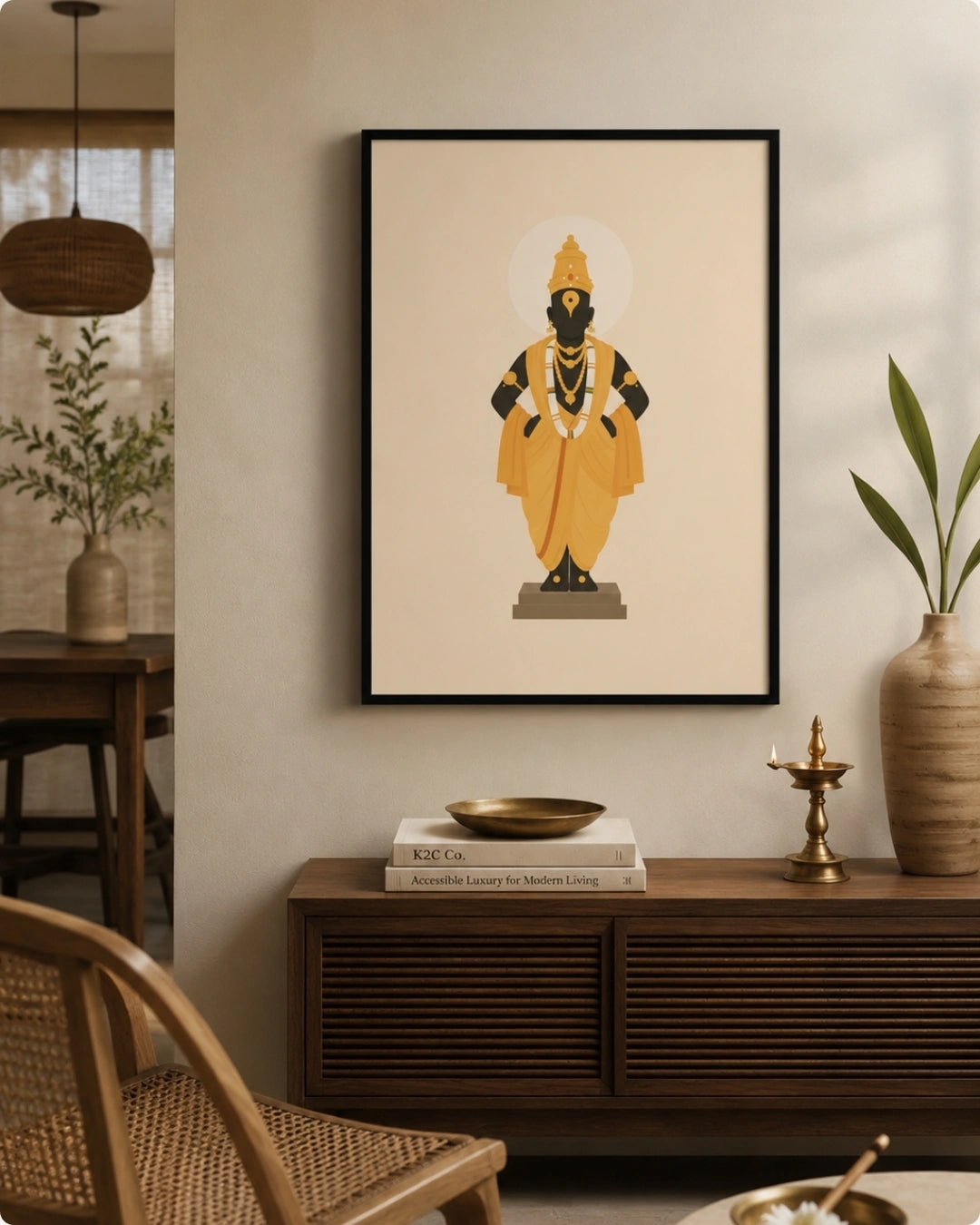 Lifestyle mockup of the Lord Vitthal wall art in a sleek black frame styled over a dark wooden console with traditional brass accents and greenery.