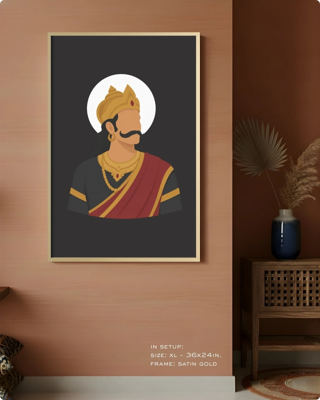A framed art print featuring a stylized illustration of Raavana in traditional Indian attire, displayed on a warm terracotta wall in a styled room setting.