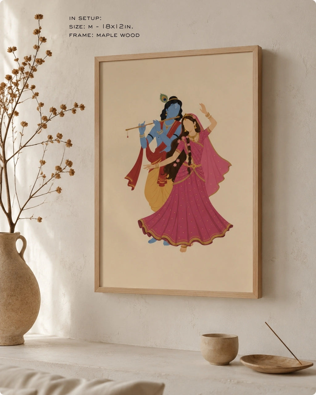 Lifestyle interior mockup of the Hindu divine couple Radha and Krishna wall art with a maple wood frame, paired with wabi-sabi elements like dry botanical branches and ceramic vases.