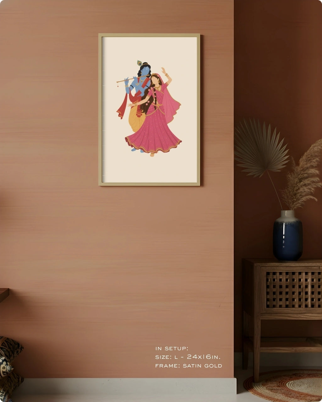 Visual size guide mockup for the Hindu divine couple Radha and Krishna wall art in Large size with a satin gold frame, displayed against a warm terracotta accent wall.