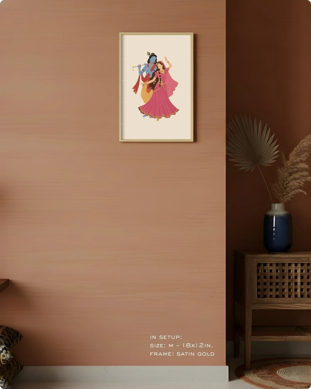 Visual size guide mockup for the Hindu divine couple Radha and Krishna wall art in Medium size with a satin gold frame, displayed against a warm terracotta accent wall.